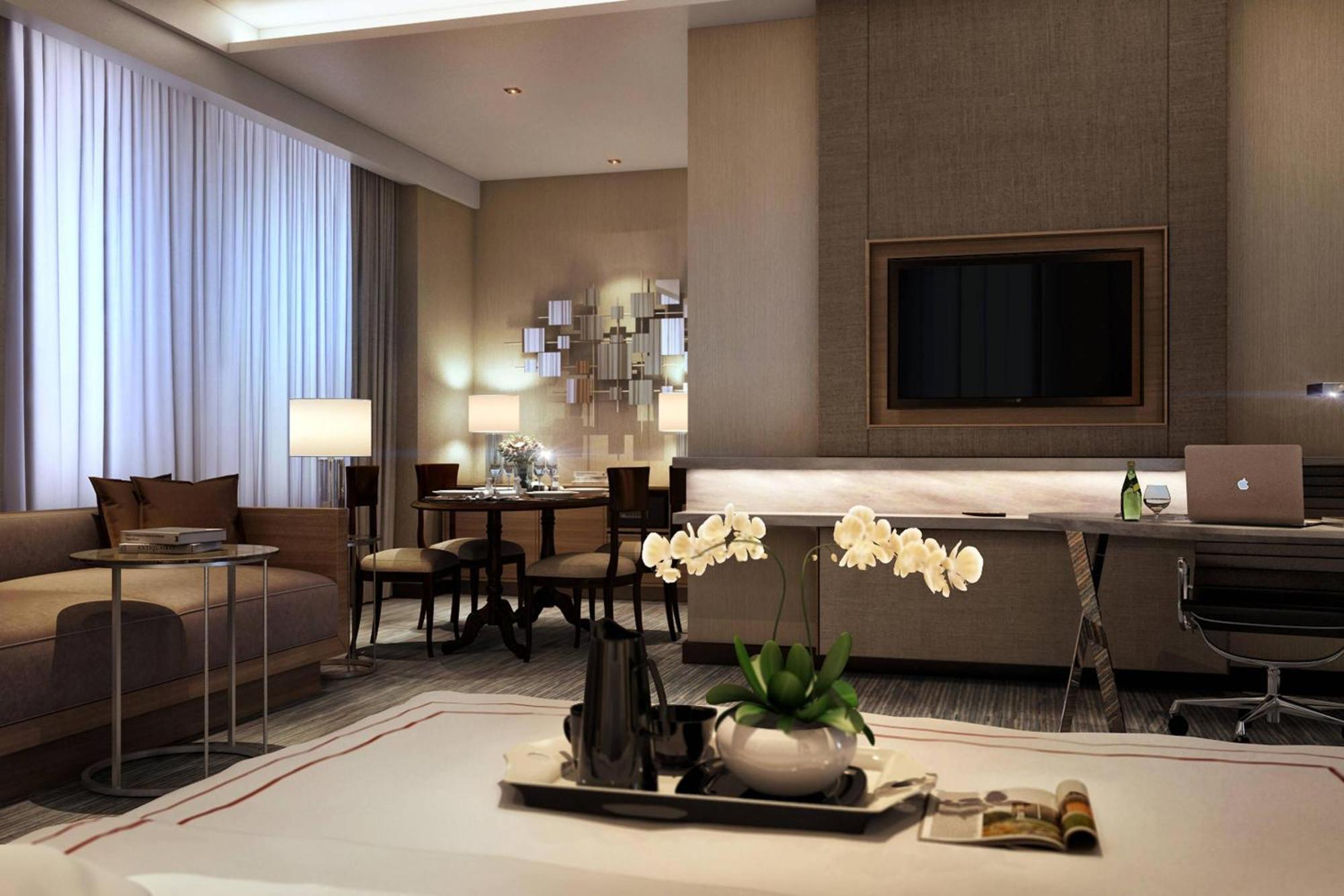 Отель Jw Marriott Куала-Лумпур Экстерьер фото The photo shows a modern hotel room or a well-designed living space. It features large windows with sheer curtains that let in natural light. Decorative elements include a coffee table and elegant furniture, with a sofa in a neutral tone. There is a 