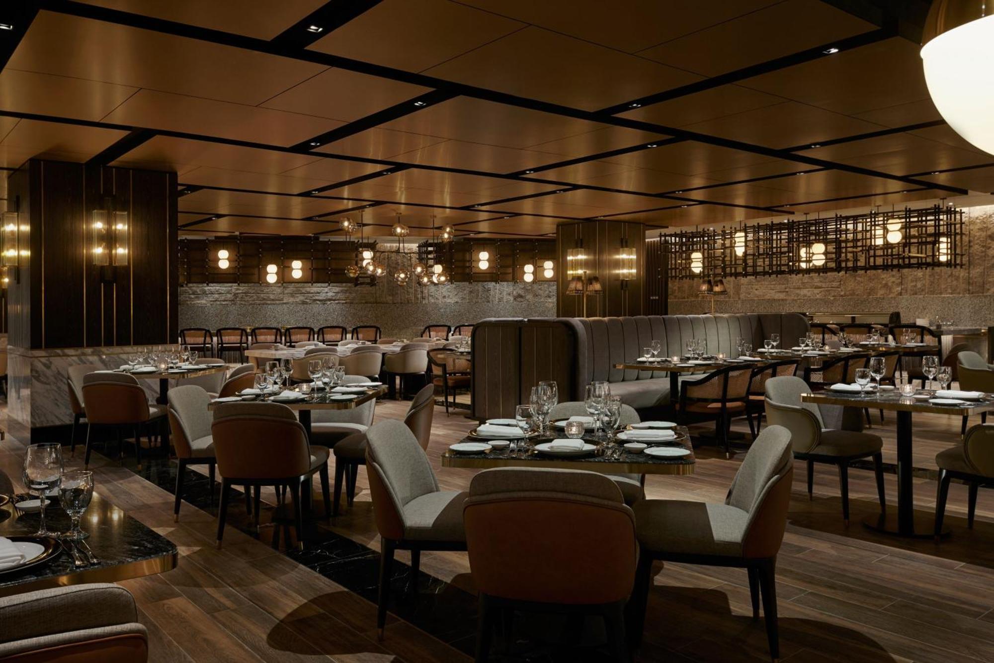 Отель Jw Marriott Куала-Лумпур Экстерьер фото The photo depicts an elegant restaurant interior. It features a spacious layout with wooden flooring and a combination of dark and light decor. The seating consists of plush chairs arranged around tables, which are set with cutlery and plates. The ce